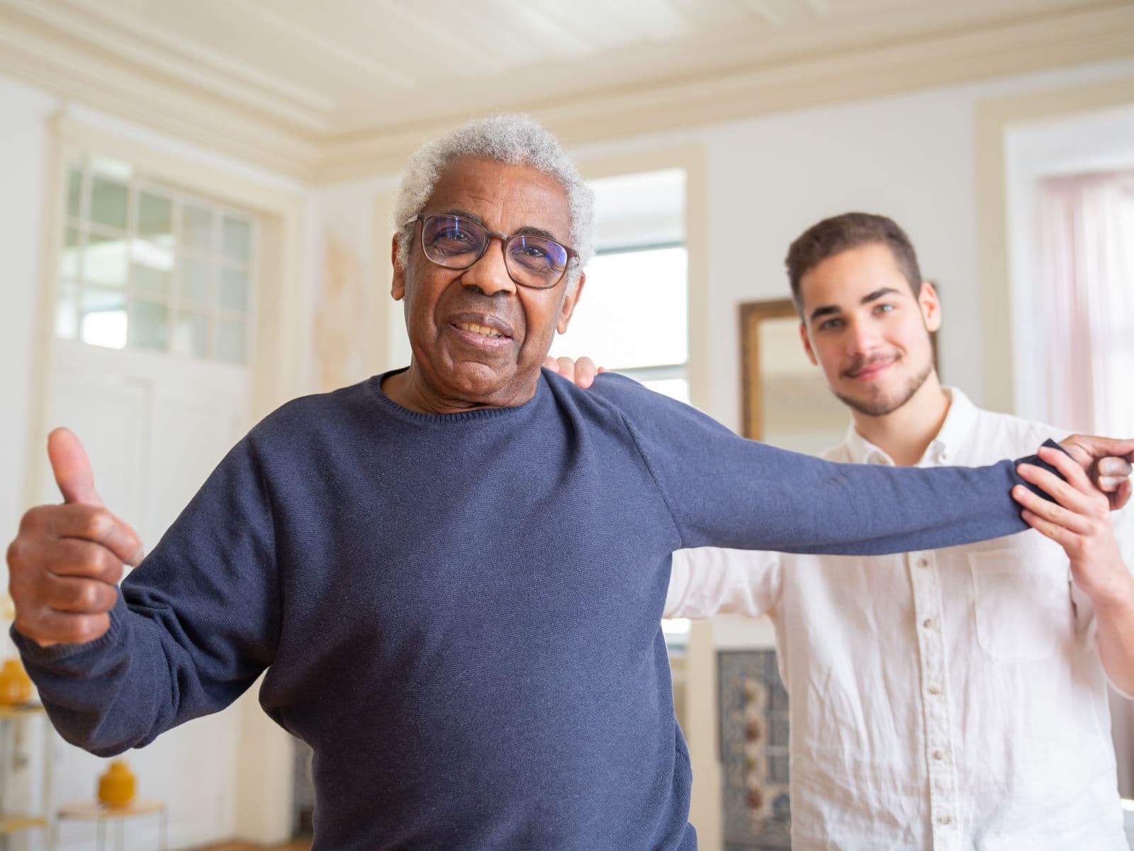 A personal support worker helping an older adult move comfortably at home
